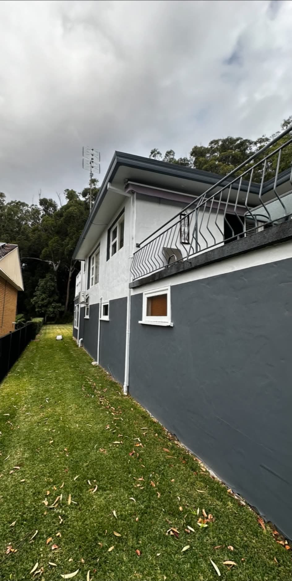 The same house repainted in charcoal and white